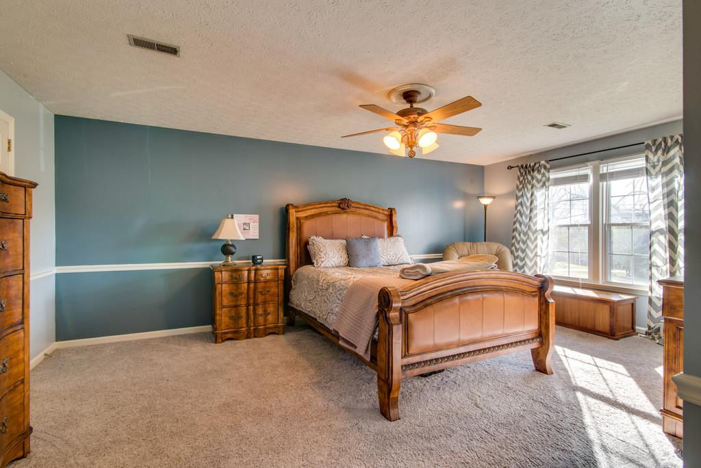 113 Shiloh Ridge Hendersonville, TN 37075 - Photo 19 of 30 a bedroom with a bed and a chandelier
