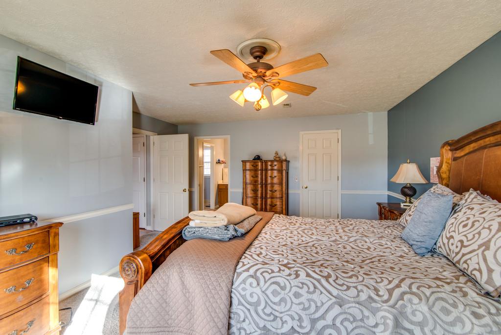 113 Shiloh Ridge Hendersonville, TN 37075 - Photo 20 of 30 a bedroom with a bed and a flat tv screen on the dresser