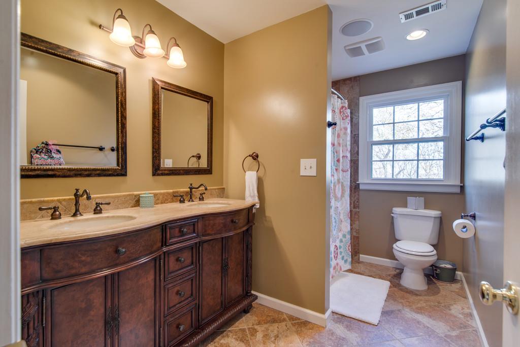 113 Shiloh Ridge Hendersonville, TN 37075 - Photo 24 of 30 a bathroom with a double vanity sink a toilet and a mirror