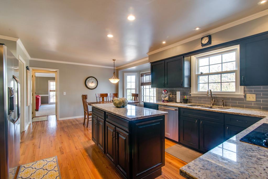 113 Shiloh Ridge Hendersonville, TN 37075 - Photo 10 of 30 a kitchen with granite countertop a sink dishwasher stove and cabinets with wooden floor