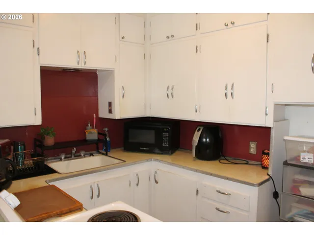 a kitchen with a sink and cabinets