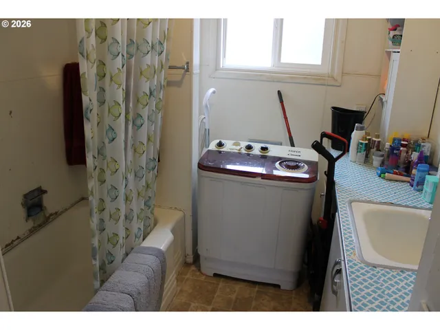 a utility room with closet dryer and washer
