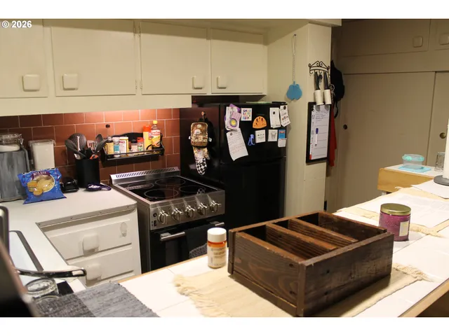 a living room with hard wood appliances