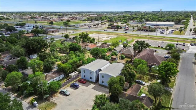 an aerial view of residential houses with outdoor space and swimming pool