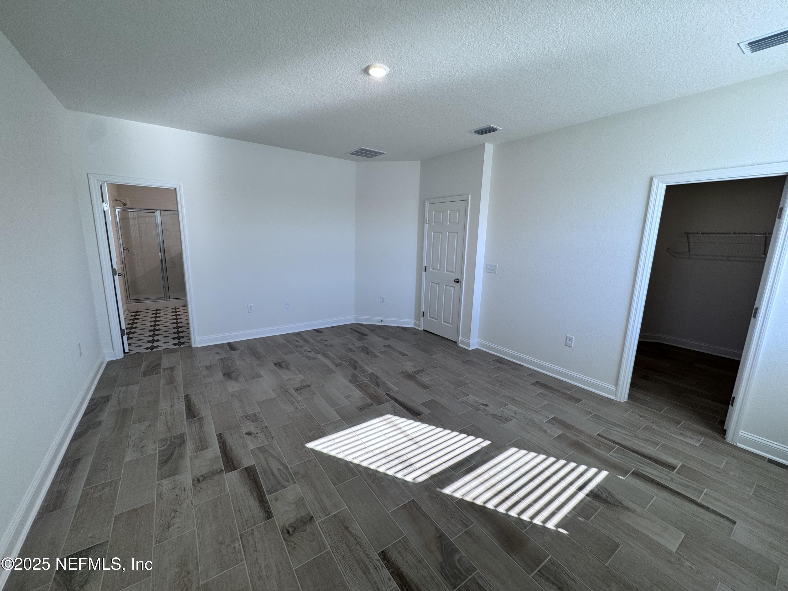 11156 Spg Mdws Road Jacksonville, FL 32222 - Photo 13 of 33 a view of a hallway with wooden floor and cabinet
