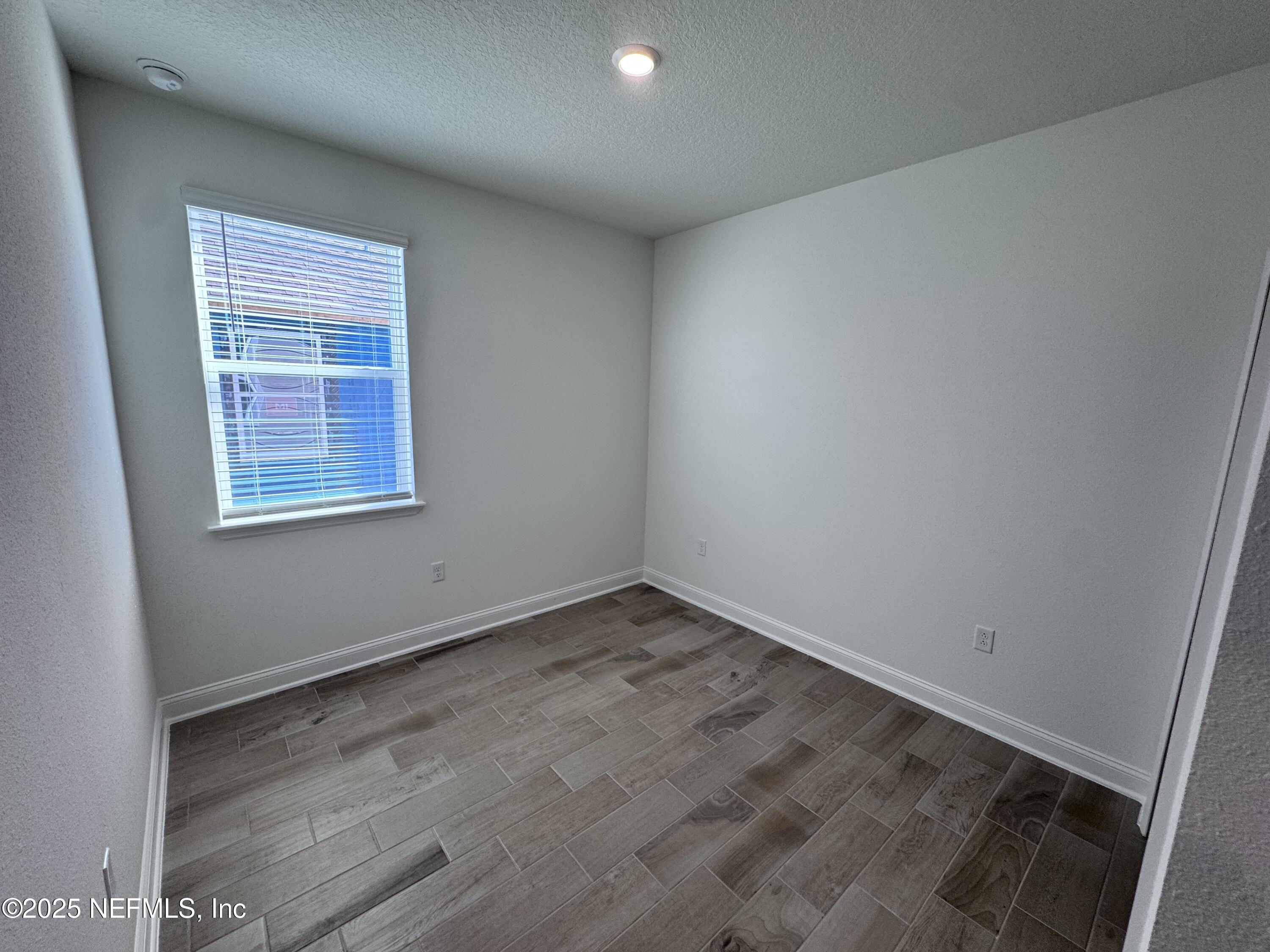 11156 Spg Mdws Road Jacksonville, FL 32222 - Photo 19 of 33 an empty room with a window