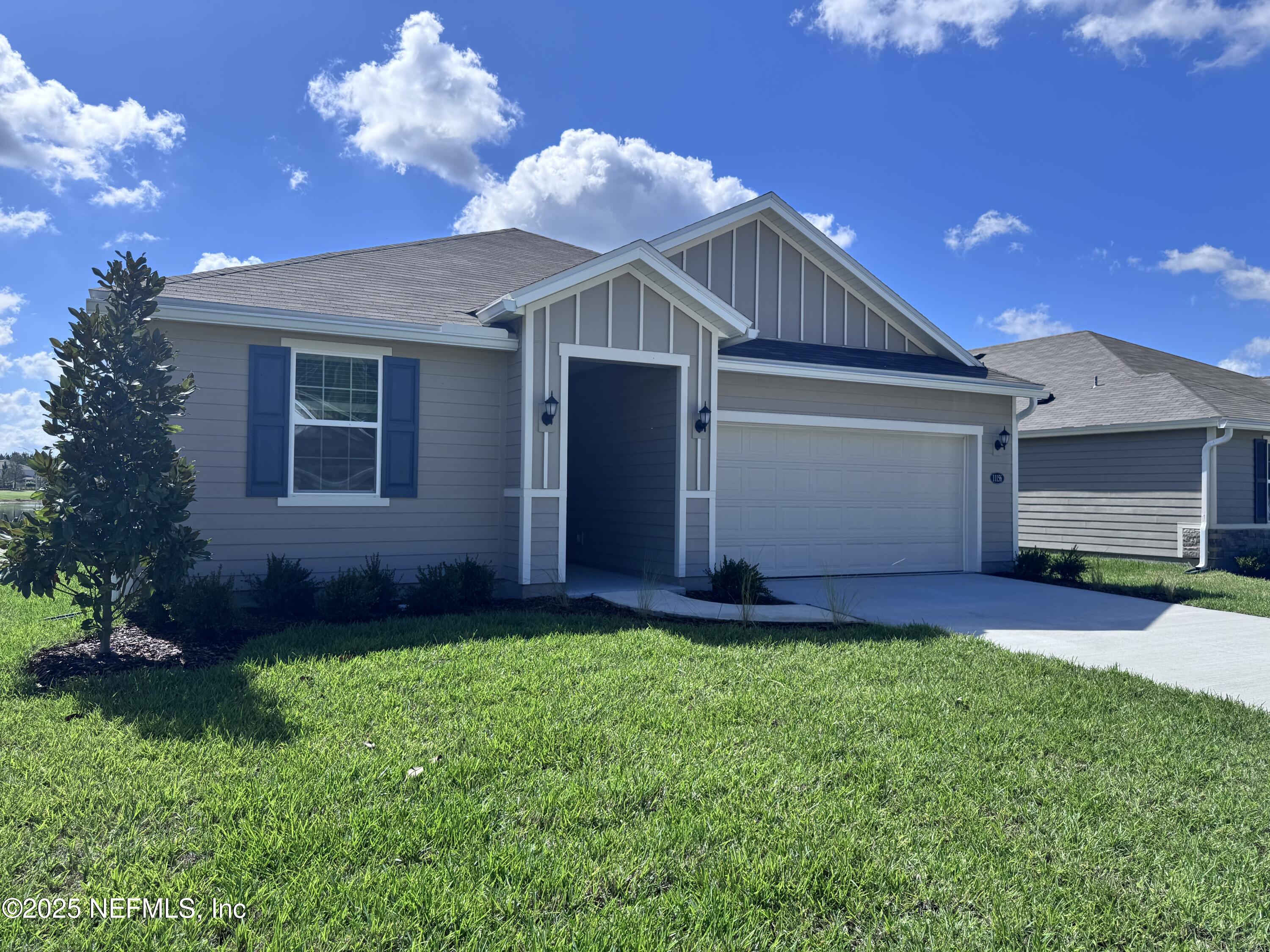 11156 Spg Mdws Road Jacksonville, FL 32222 - Photo 2 of 33 a front view of a house with a yard and garage
