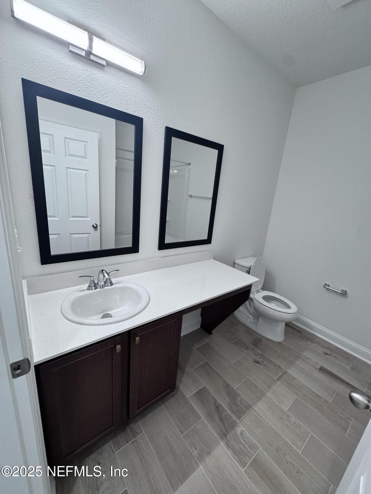11156 Spg Mdws Road Jacksonville, FL 32222 - Photo 21 of 33 a bathroom with a sink and a mirror