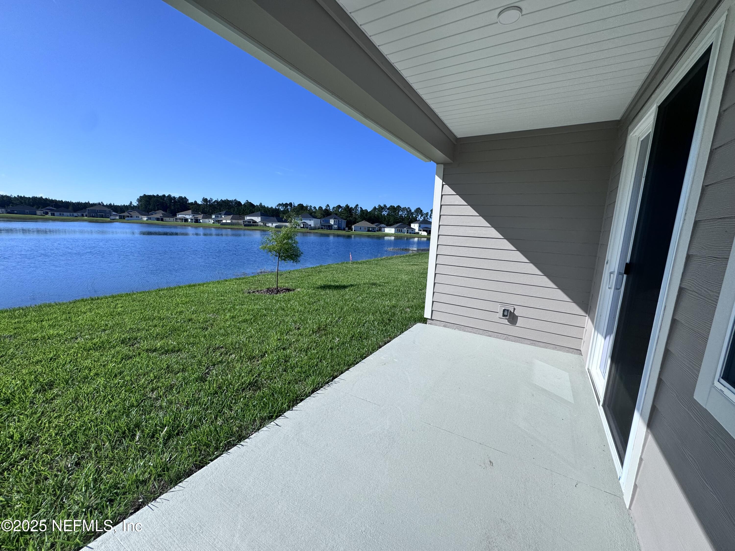 11156 Spg Mdws Road Jacksonville, FL 32222 - Photo 31 of 33 a view of a backyard with plants and a lake view
