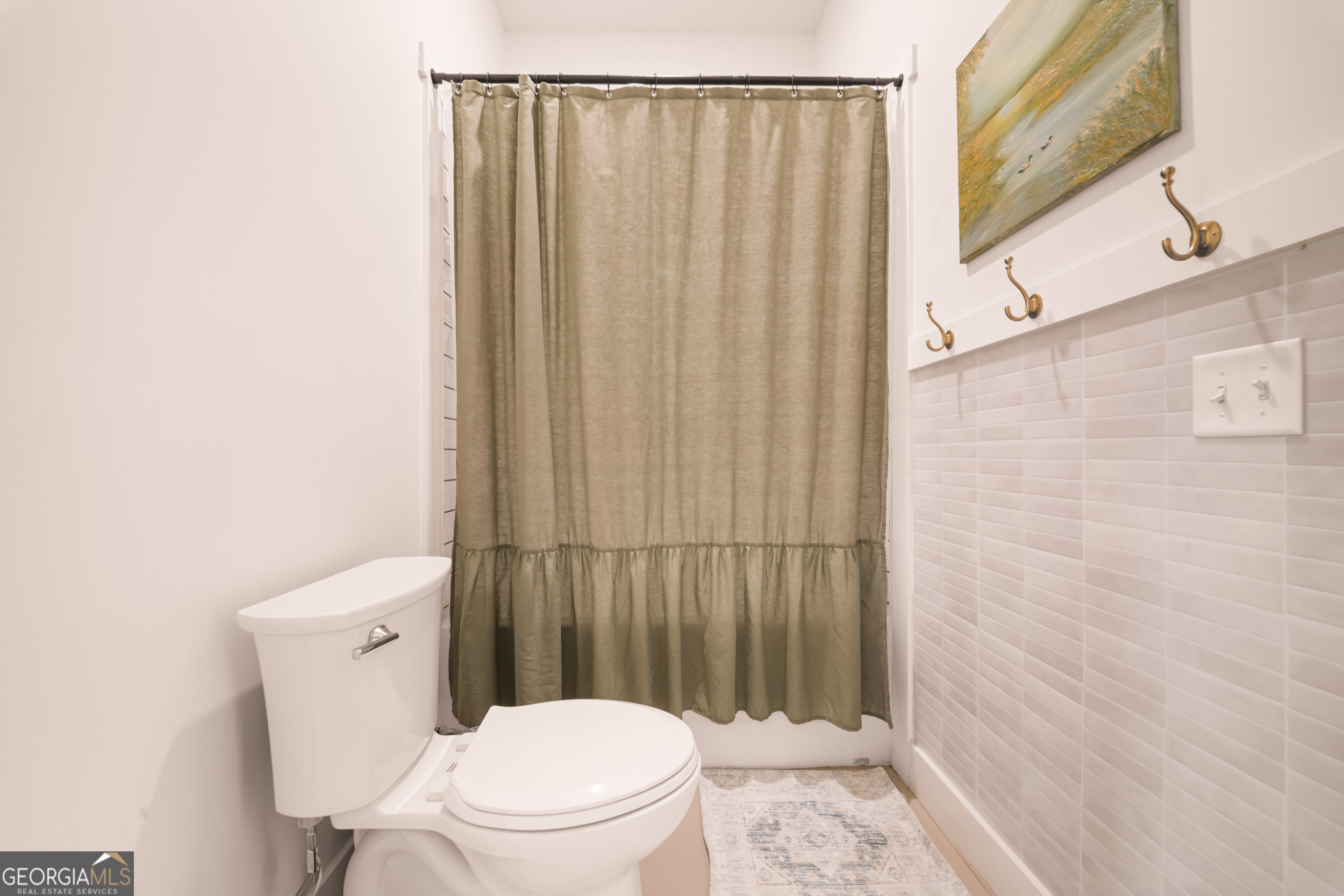 2973 Buttermilk Road Sylvania, GA 30467 - Photo 22 of 48 a white toilet sitting next to a shower curtain