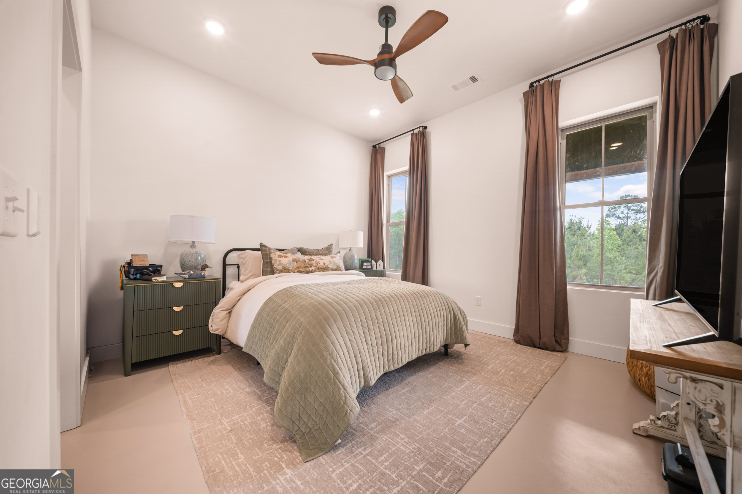 2973 Buttermilk Road Sylvania, GA 30467 - Photo 24 of 48 a spacious bedroom with a bed and a chandelier
