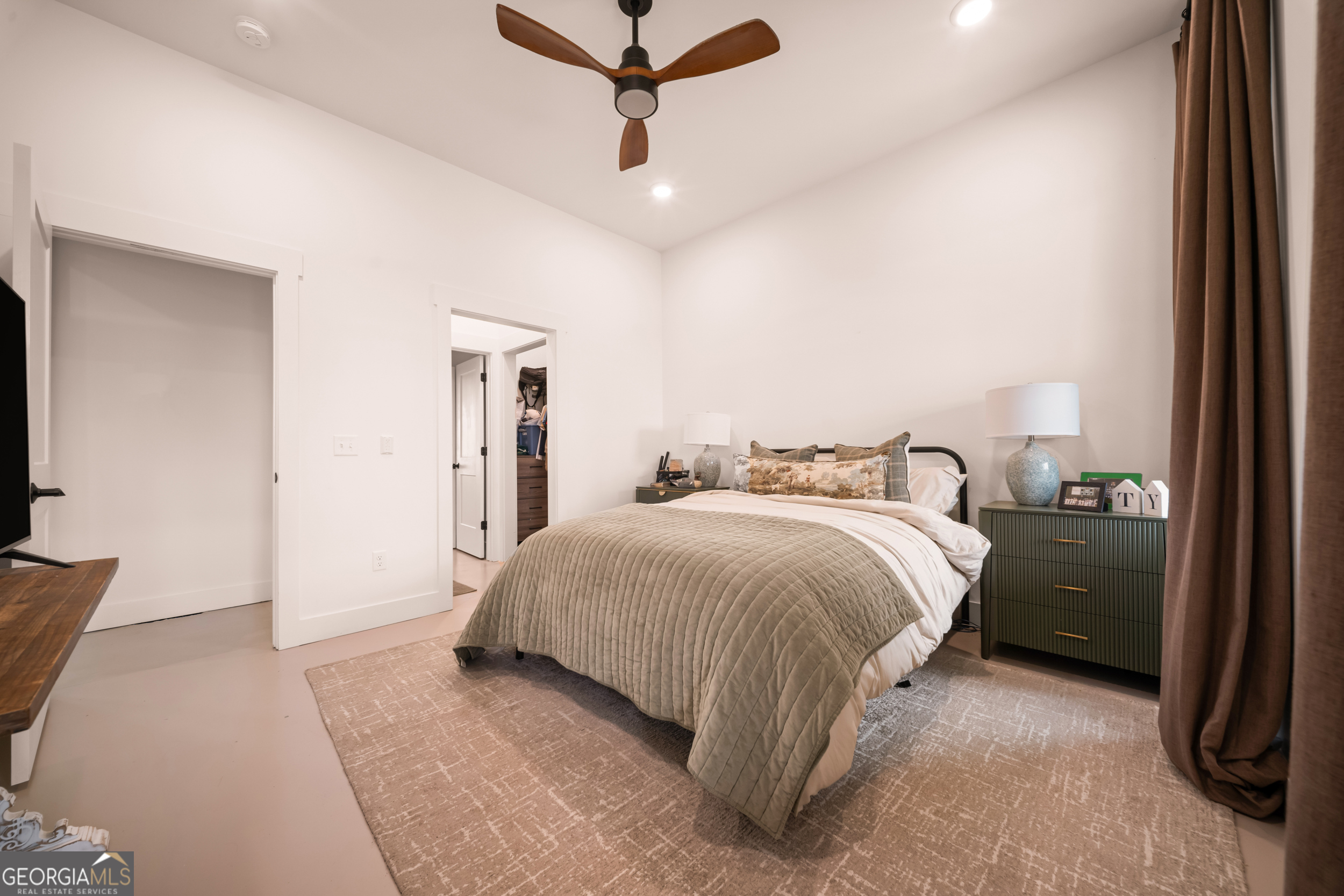 2973 Buttermilk Road Sylvania, GA 30467 - Photo 25 of 48 a spacious bedroom with a bed and a chandelier