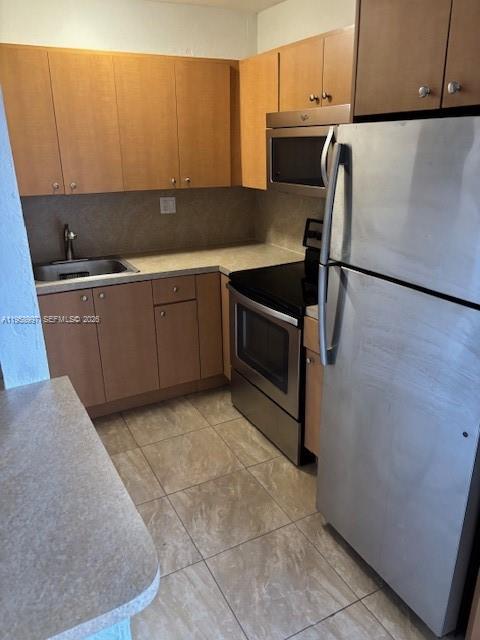4444 Southwest 67th Avenue, Unit 12 Miami, FL 33155 - Photo 2 of 6 a kitchen with stainless steel appliances a refrigerator sink and cabinets