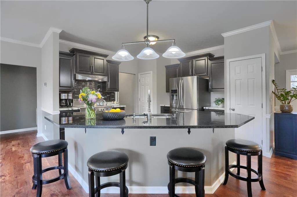 119 Caromar Drive Mars, PA 16046 - Photo 17 of 48 a kitchen with stainless steel appliances a table chairs and chandelier