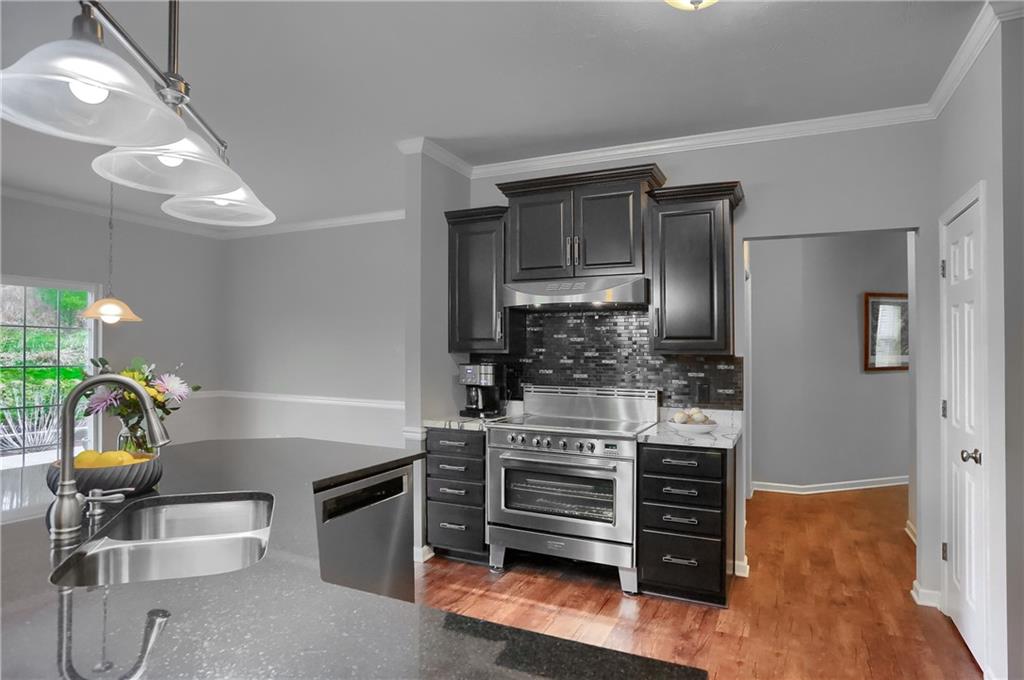 119 Caromar Drive Mars, PA 16046 - Photo 19 of 48 a kitchen with stainless steel appliances a stove a chimney a sink and cabinets