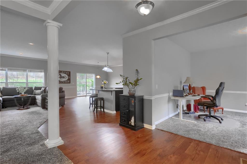 119 Caromar Drive Mars, PA 16046 - Photo 9 of 48 a living room with furniture and a dining table with wooden floor