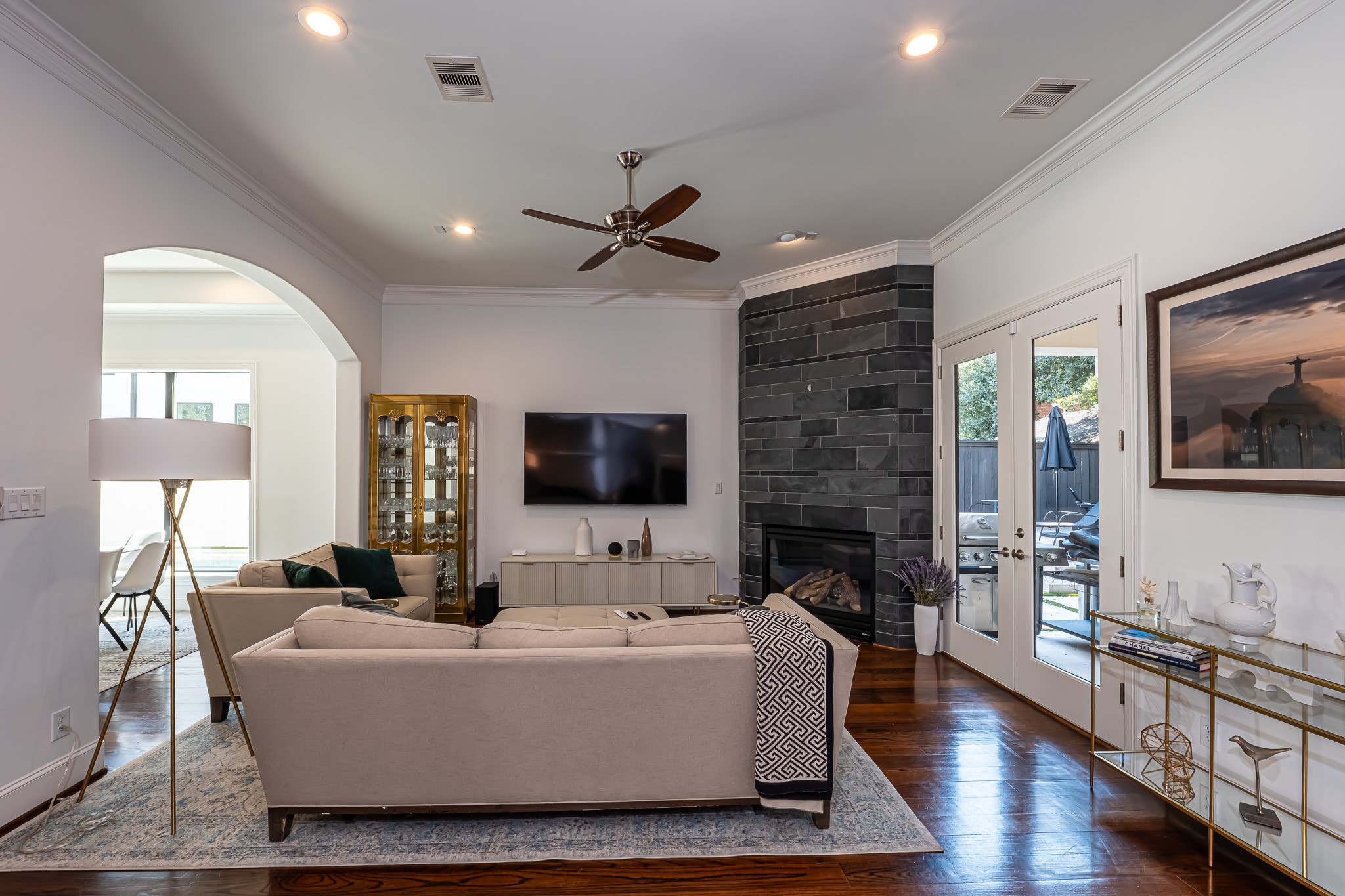 1409 Indiana Street Houston, TX 77006 - Photo 22 of 47 a living room with furniture a fireplace a flat screen tv and wooden floor