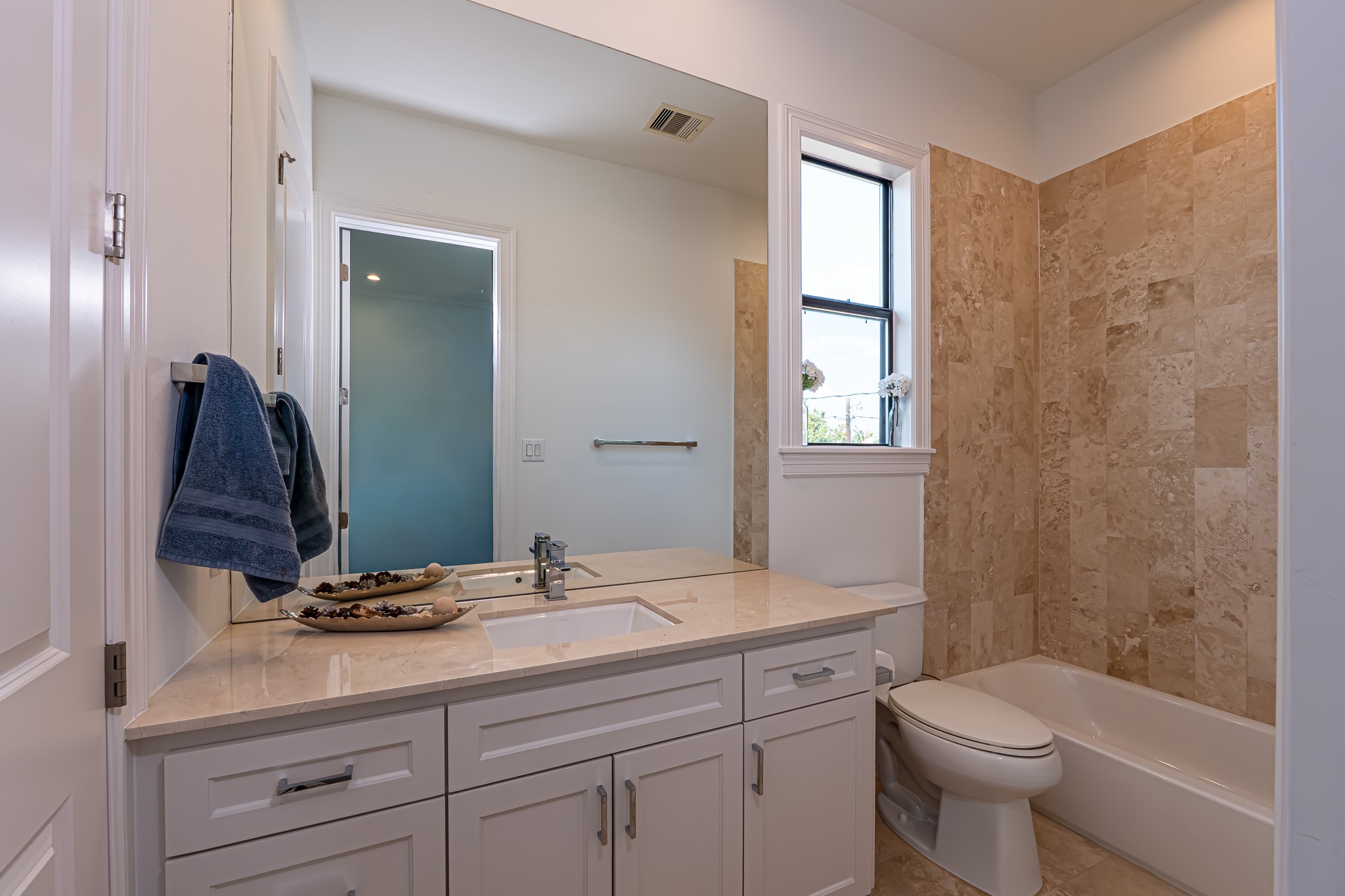 1409 Indiana Street Houston, TX 77006 - Photo 29 of 47 a bathroom with a granite countertop toilet a sink and a mirror