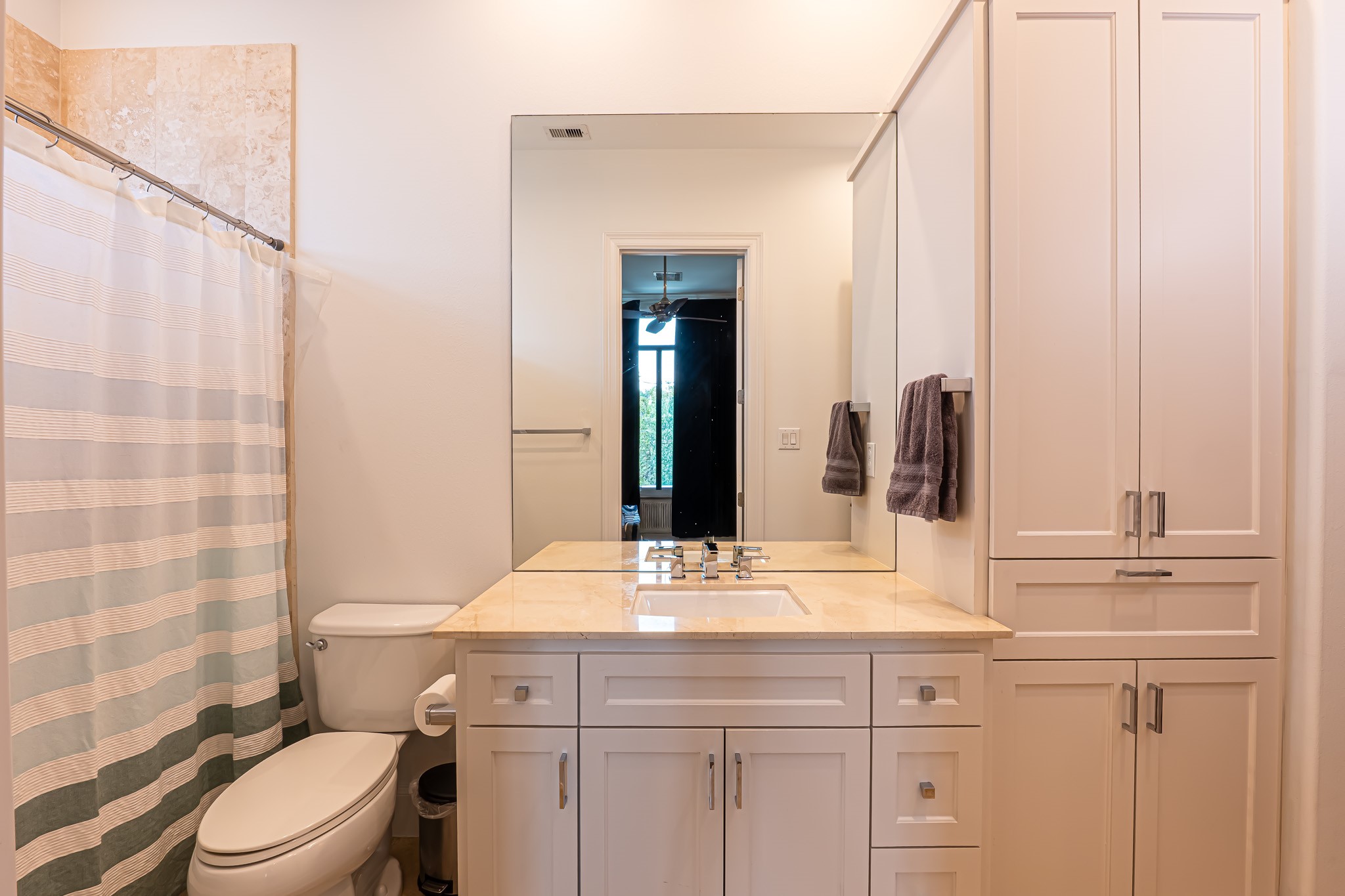 1409 Indiana Street Houston, TX 77006 - Photo 40 of 47 a bathroom with a granite countertop sink a toilet and a mirror