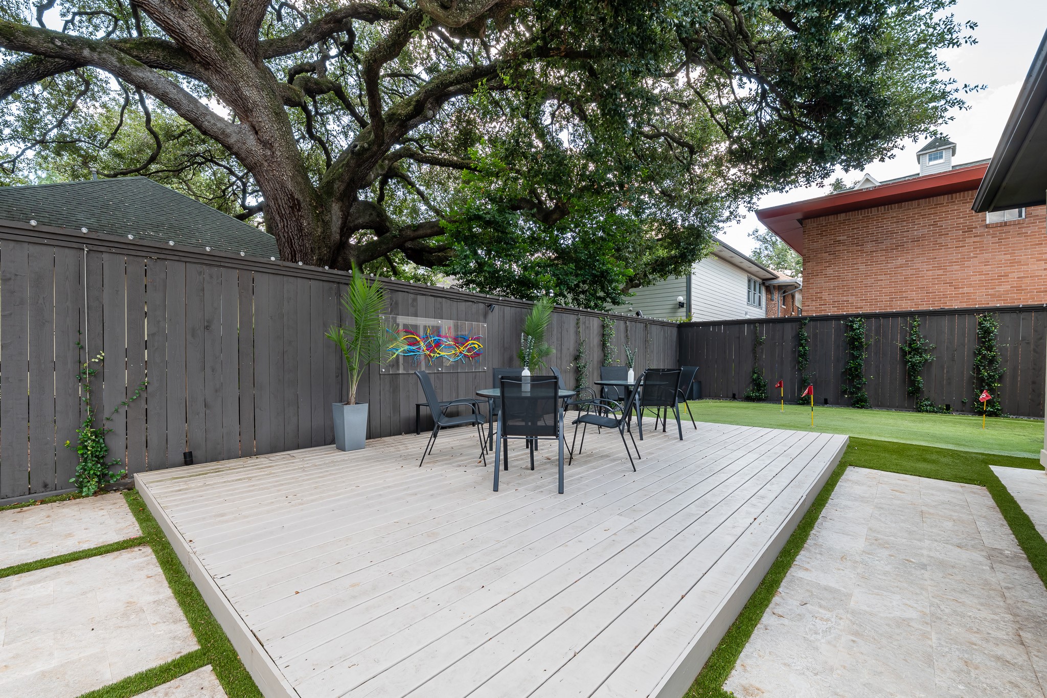 1409 Indiana Street Houston, TX 77006 - Photo 5 of 47 a view of backyard with table and chairs and wooden fence