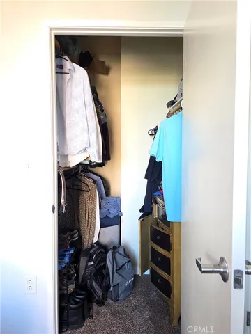 a living room with furniture kitchen view and a window