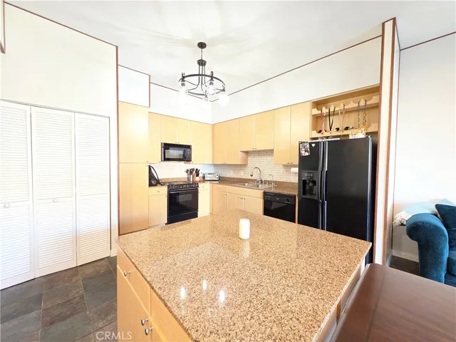 a kitchen with stainless steel appliances granite countertop a refrigerator a oven a sink and dishwasher