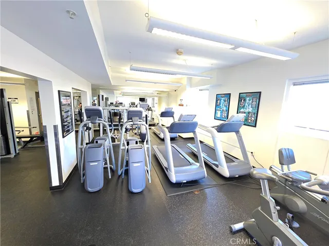 a dining hall with stainless steel appliances granite countertop a refrigerator and a stove