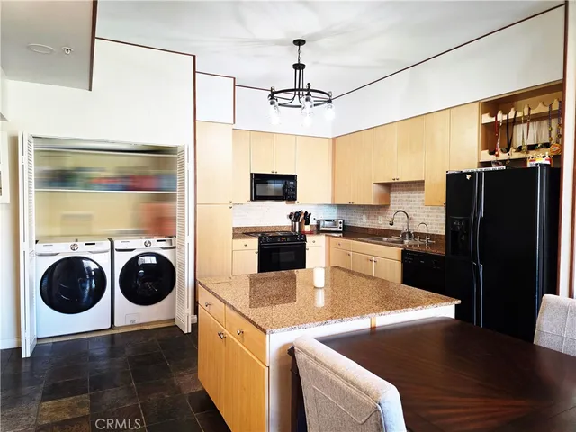 a living room with furniture and kitchen view
