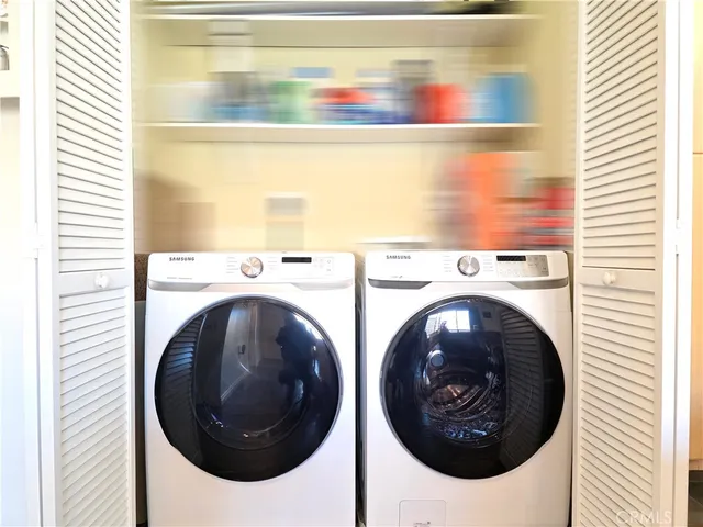 a living room with furniture a rug and a chandelier