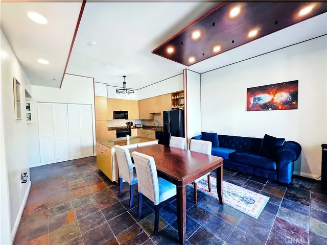 a view of a hallway with furniture and a potted plant