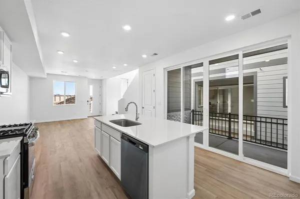 a kitchen with a sink and a stove top oven