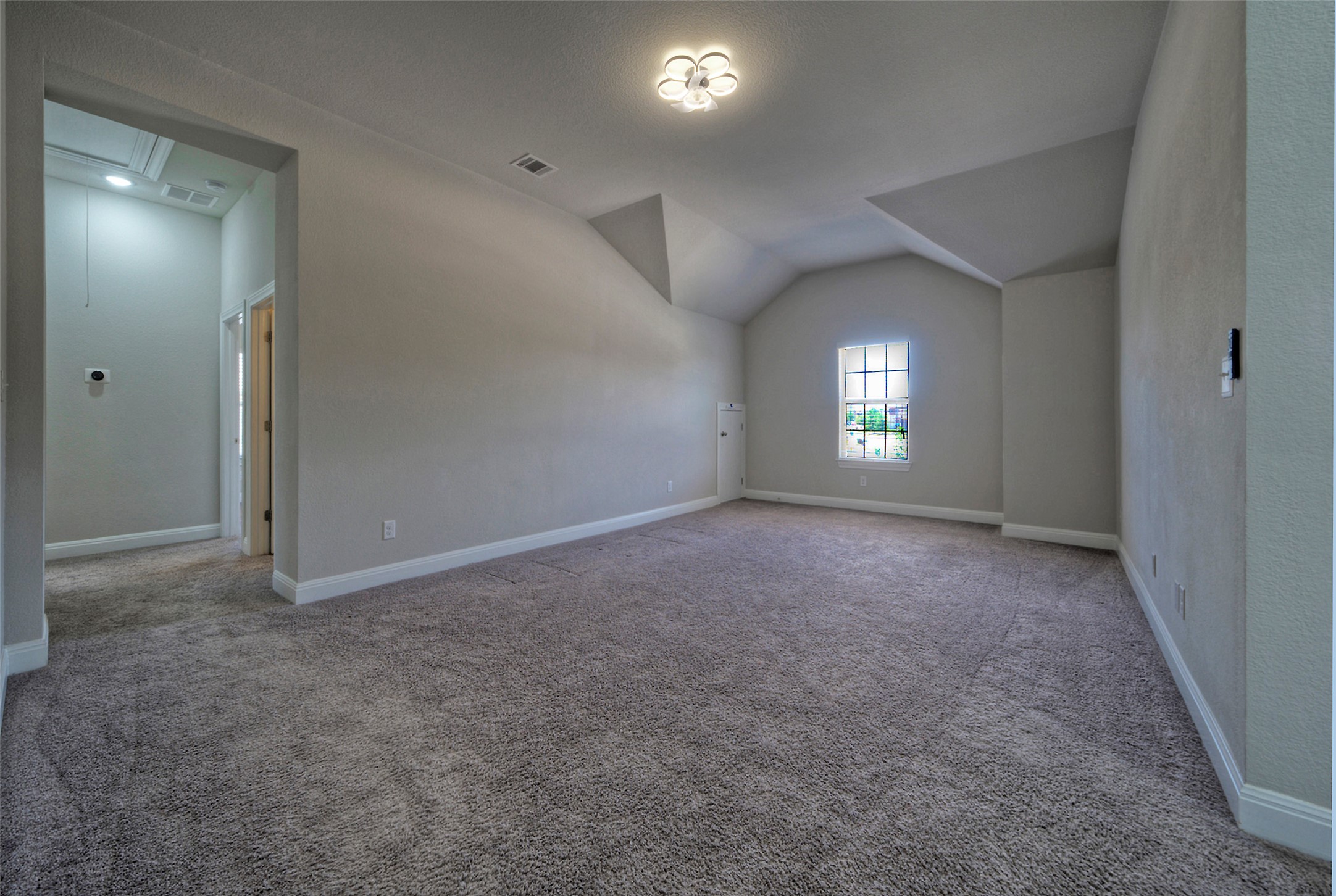 2260 Hat Bender Loop Round Rock, TX 78664 - Photo 19 of 40 A spacious room offers ample potential, featuring soft carpeting and an inviting window.