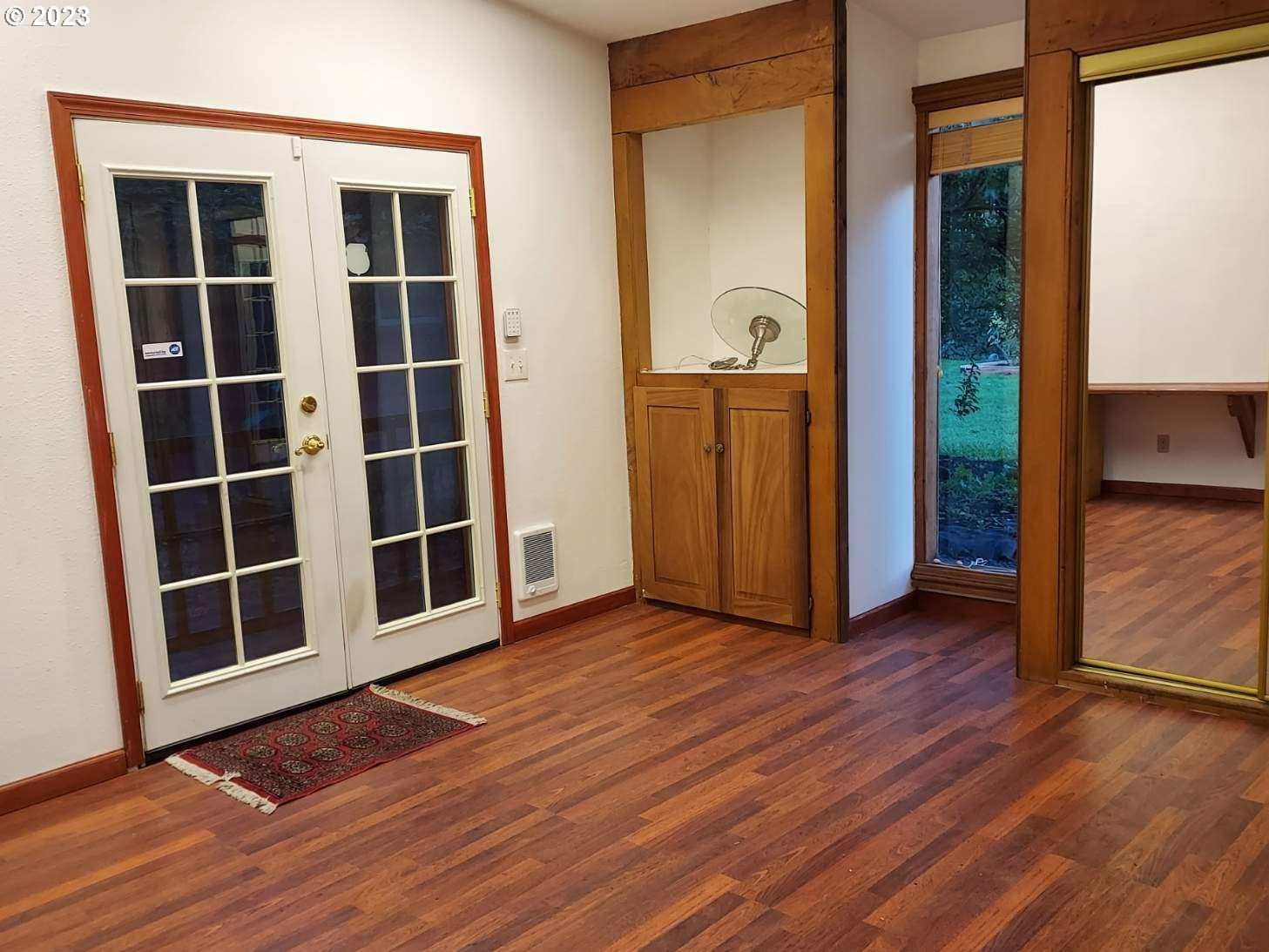 460 37th Street Springfield, OR 97478 - Photo 17 of 21 an empty room with wooden floor and windows