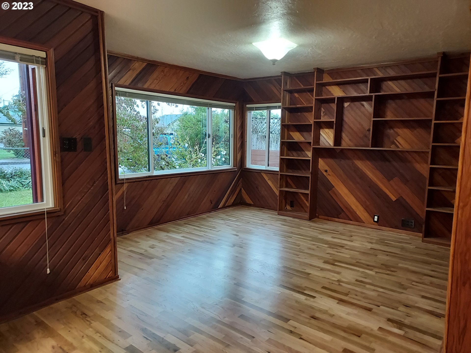 460 37th Street Springfield, OR 97478 - Photo 5 of 21 wooden floor in an empty room with a window