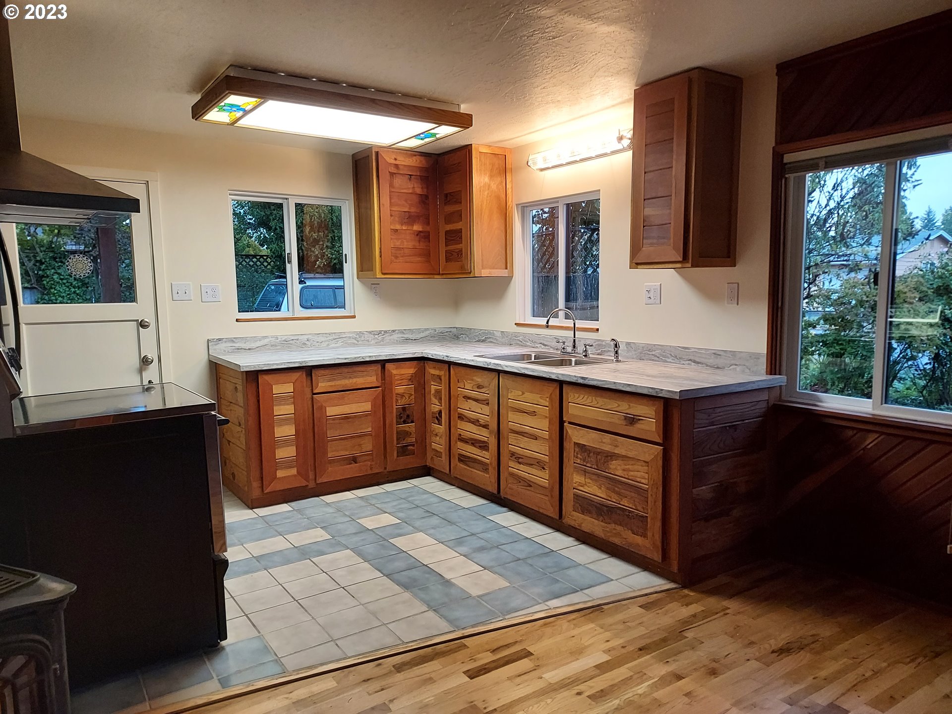 460 37th Street Springfield, OR 97478 - Photo 7 of 21 a kitchen with stainless steel appliances granite countertop a stove a sink and a microwave