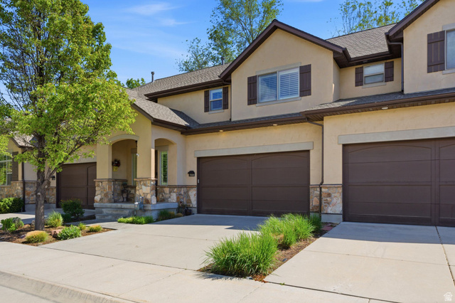 7235 Viansa Court Midvale, UT 84047 - Photo 1 of 43 Traditional home with stone siding, stucco siding, driveway, and an attached garage