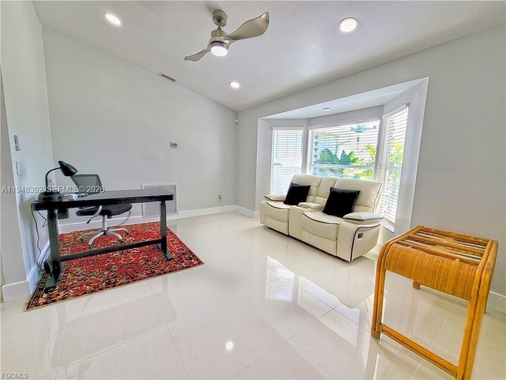 237 Southwest 47th Street Cape Coral, FL 33914 - Photo 14 of 50 a living room with furniture and a large window