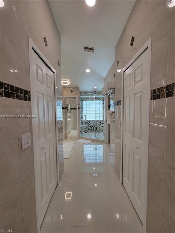 237 Southwest 47th Street Cape Coral, FL 33914 - Photo 23 of 50 a bathroom with a glass shower door and a sink