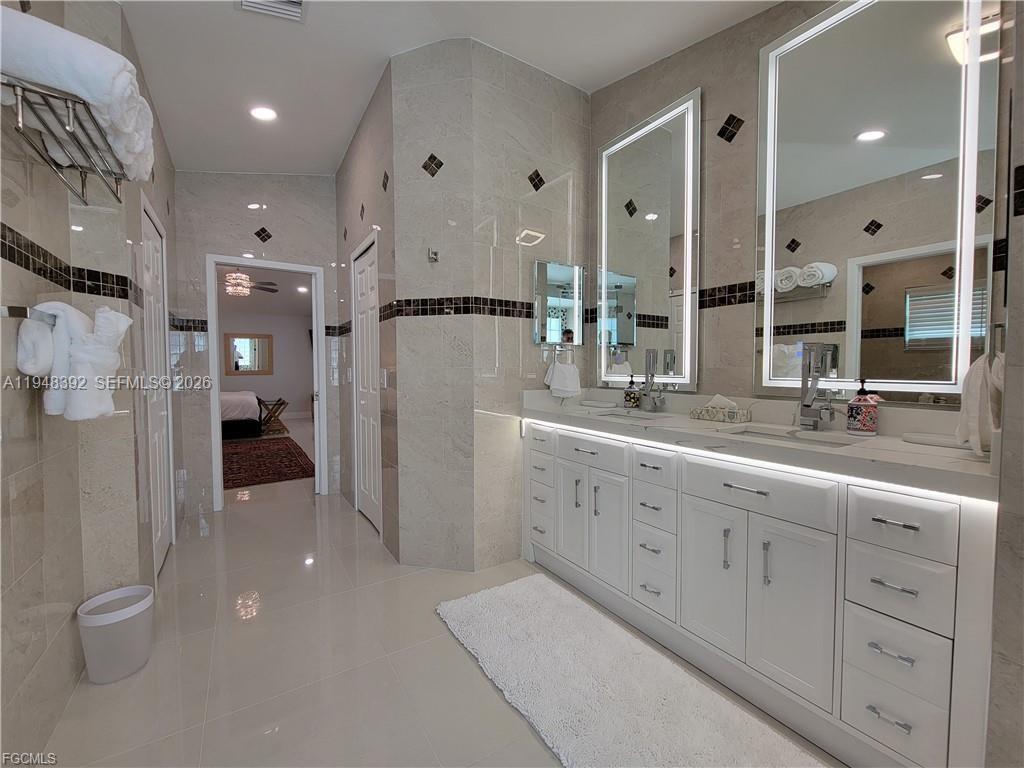 237 Southwest 47th Street Cape Coral, FL 33914 - Photo 26 of 50 a bathroom with a double vanity sink toilet and shower