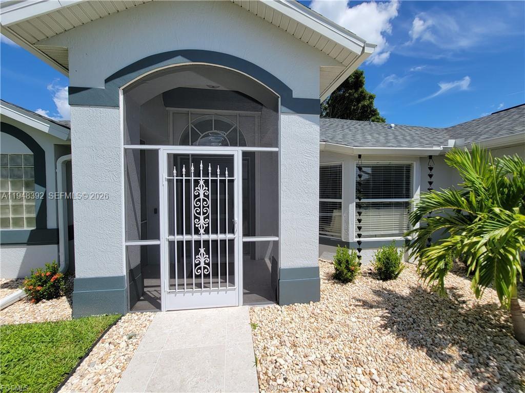 237 Southwest 47th Street Cape Coral, FL 33914 - Photo 3 of 50 a front view of a house with a porch