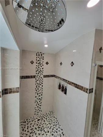 a white toilet sitting next to a bathroom sink