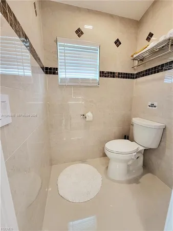 a view of an empty room with a fireplace and cabinet