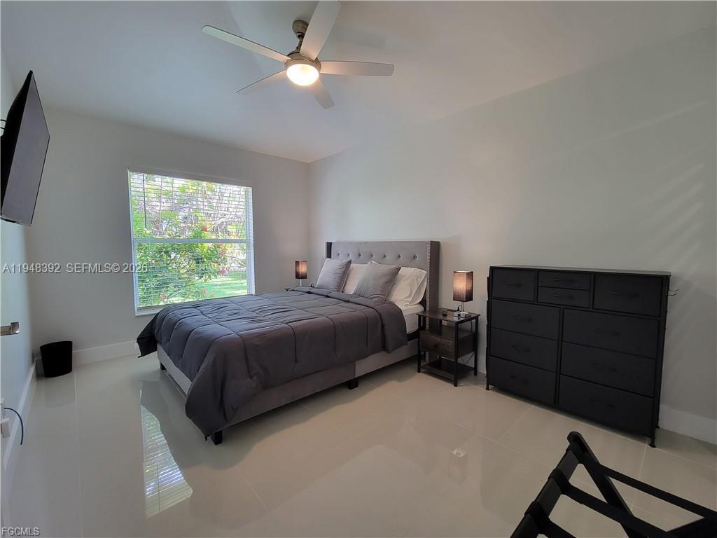 237 Southwest 47th Street Cape Coral, FL 33914 - Photo 35 of 50 a bedroom with a bed and a ceiling fan