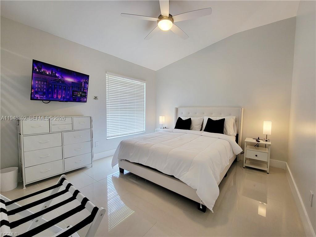 237 Southwest 47th Street Cape Coral, FL 33914 - Photo 41 of 50 a bedroom with a bed and a night stand