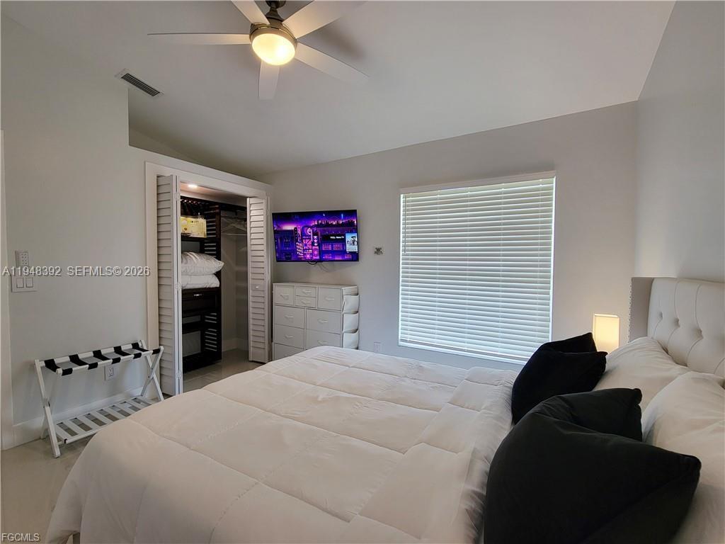 237 Southwest 47th Street Cape Coral, FL 33914 - Photo 42 of 50 a bedroom with a bed and a chandelier