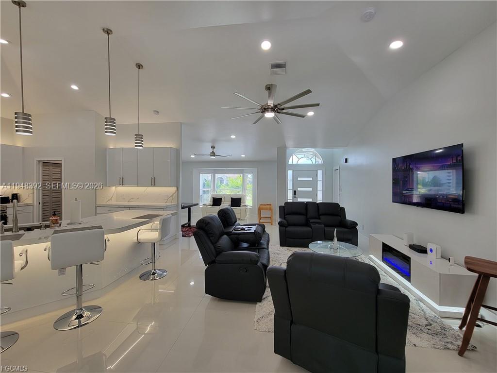 237 Southwest 47th Street Cape Coral, FL 33914 - Photo 5 of 50 a living room with furniture and a flat screen tv