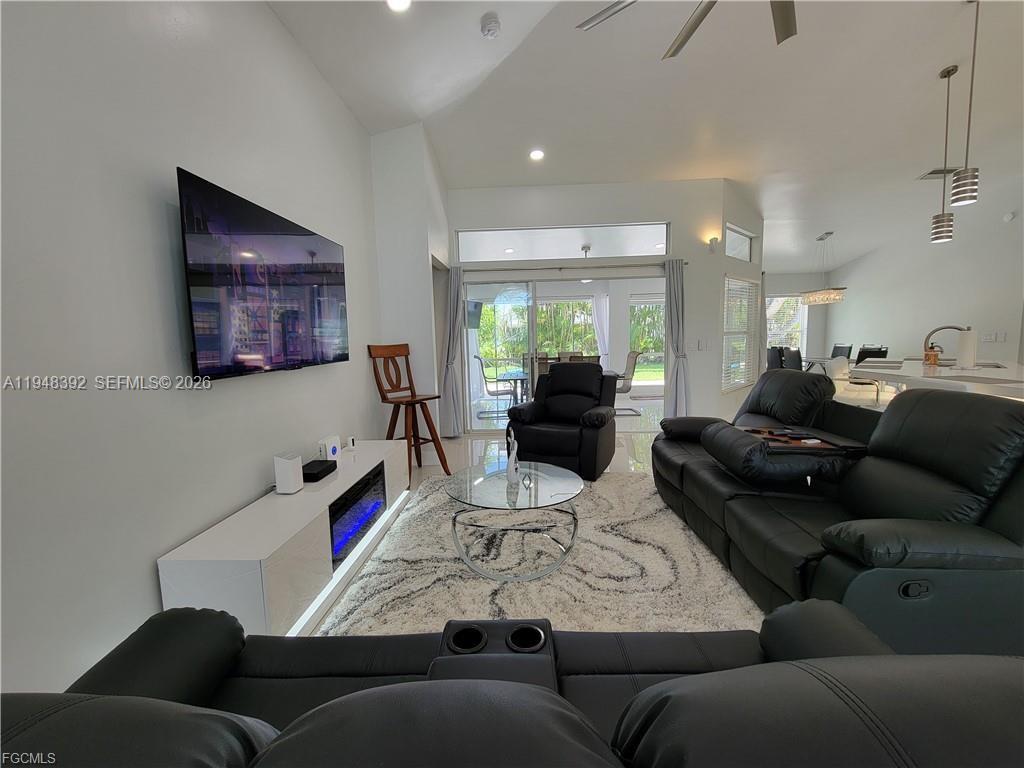 237 Southwest 47th Street Cape Coral, FL 33914 - Photo 7 of 50 a living room with furniture and a flat screen tv