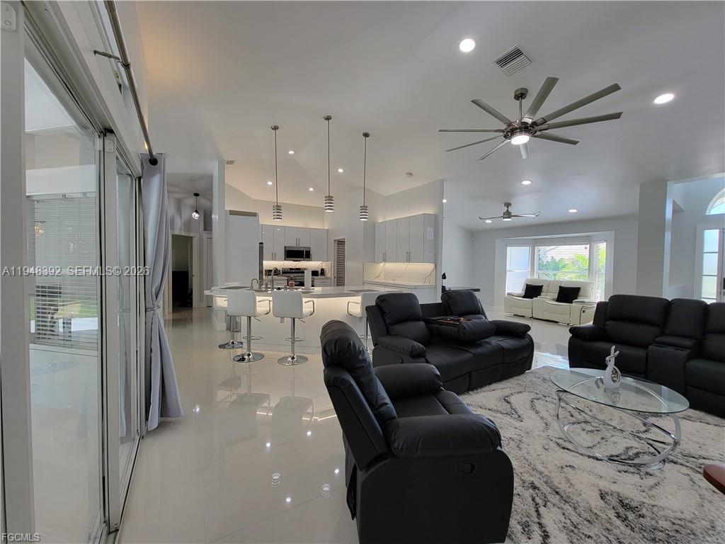 237 Southwest 47th Street Cape Coral, FL 33914 - Photo 8 of 50 a living room with furniture and a chandelier