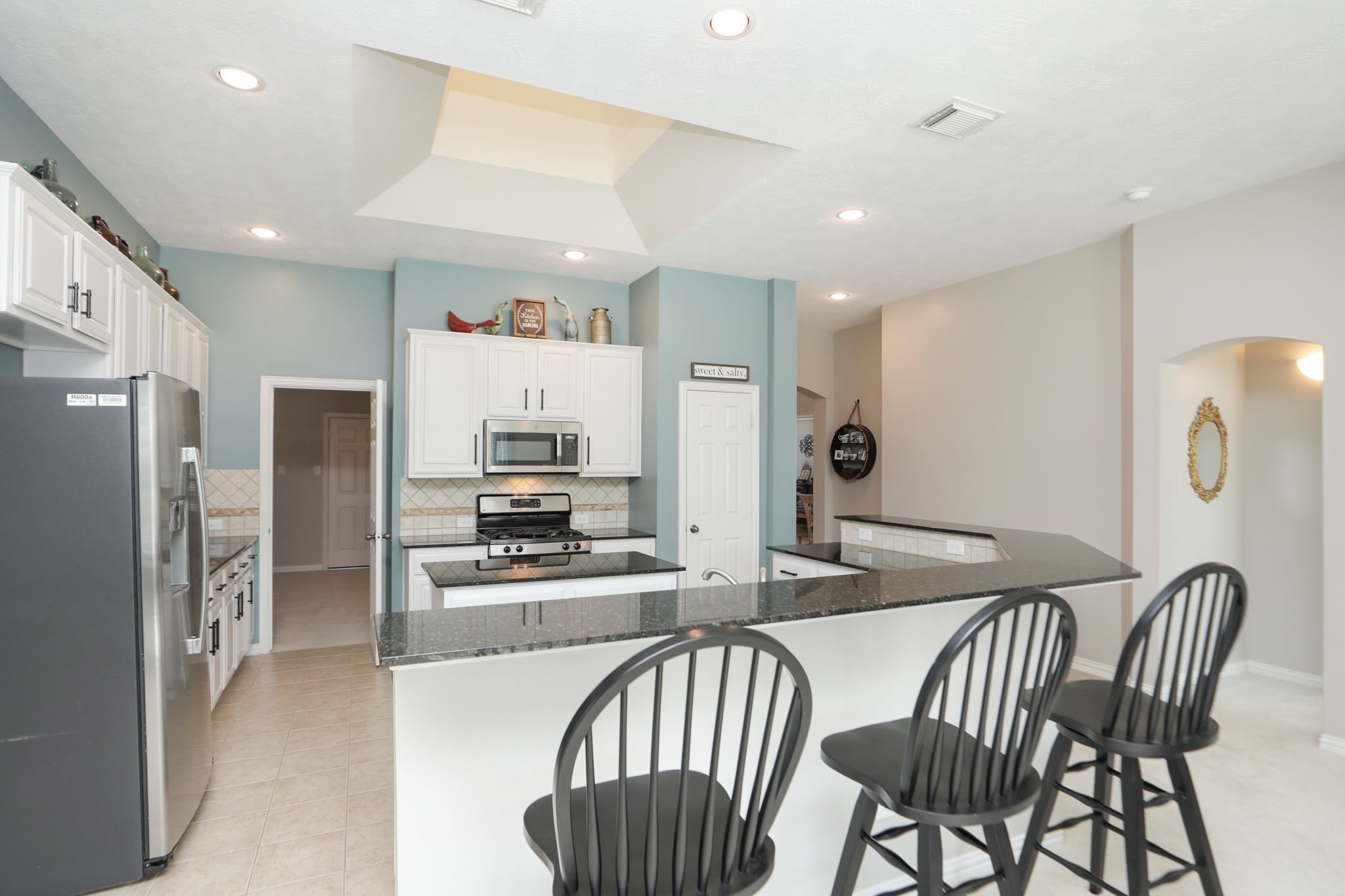 1214 Berwick Manor Court Spring, TX 77379 - Photo 21 of 49 Recent soft tone paint nd the entire inside was repainted. Plenty of countertop seating.Doorway leads to gameroom.