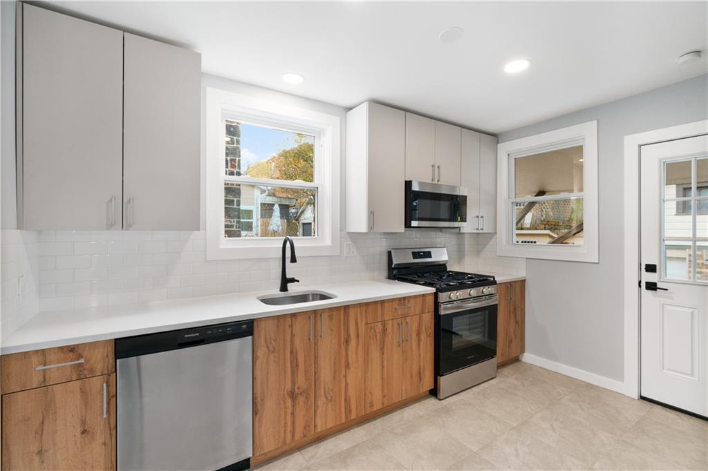 3030 Shady Avenue Pittsburgh, PA 15217 - Photo 12 of 31 a kitchen with a sink stove and microwave